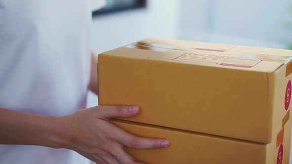 Hand packing boxes for products to send to customers.