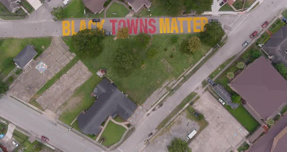 Bird eye view of a large "Black Towns Matter" sign painted on street in Houston Historical independe