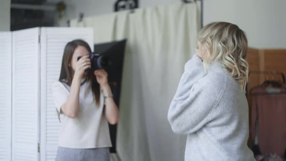 Beautiful Woman Poses To the Photographer at the Christmas Photoshoot, at the Photo Studio