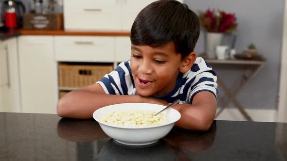 Boy having breakfast in kitchen 