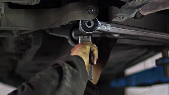 Changing The Car Undercarriage Suspension Arm In The Repair Shop 2