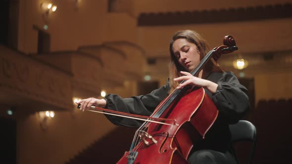 Emotional Woman is Playing Violoncello in Music Hall Female Violoncellist on Scene