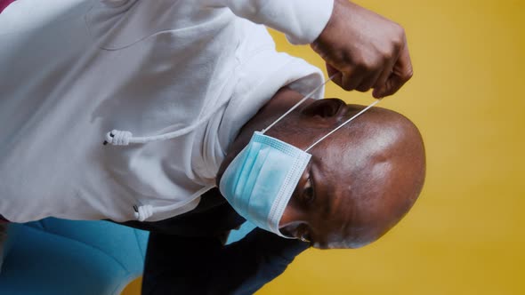 AfricanAmerican Man Wears a Blue Medical Mask on His Face