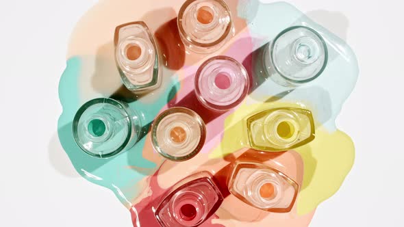 Multicolored Nail Polish Samples Spilled on White Background Isolated