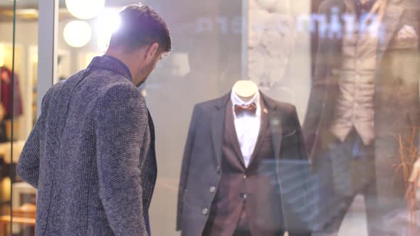 Man Looking at Suit in a Shop Window