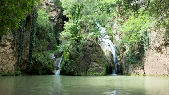 Low Angle Drone Shot of Waterfall in the Mountains