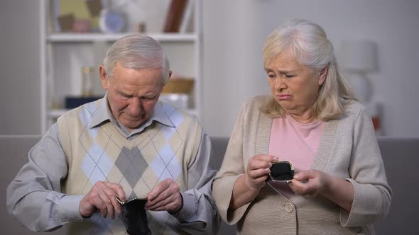 Elderly Couple Showing Empty Wallets, Lack of Money, Social and Life Problems