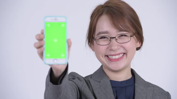 Face of Young Happy Asian Businesswoman Showing Phone