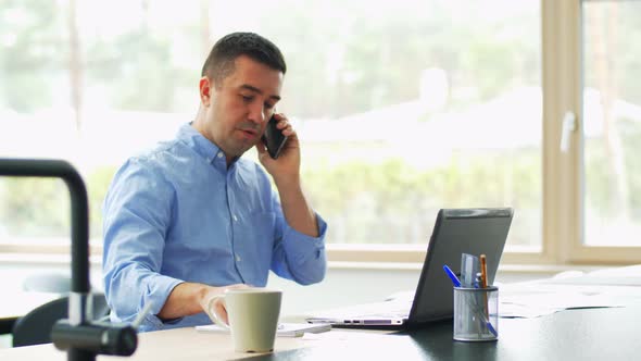 Man Calling on Smartphone at Home Office