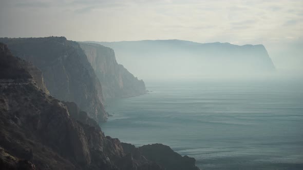 Snowy Winter Morning Over Sea Landscape and Volcanic Rocky Coastline