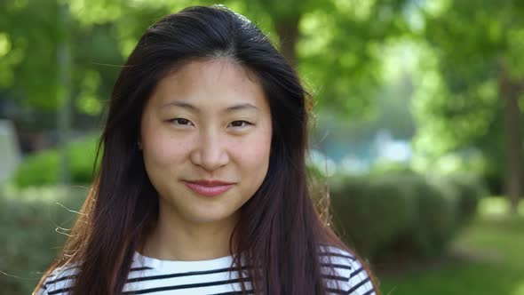 Teenager Female Asian Student Smiling at Camera Outdoors