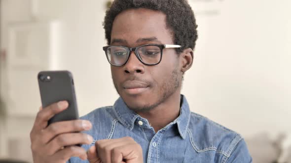 African Man Browsing Smartphone