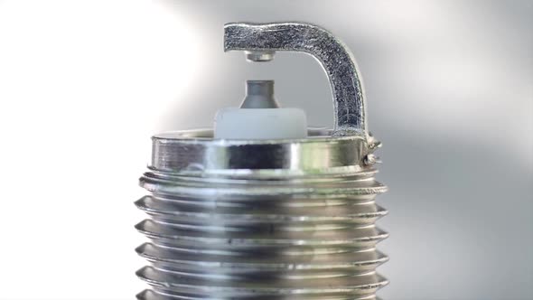 Macro View of a New Spark Plug. Rotation