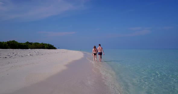 Beautiful lady and man married on vacation have fun on beach on white sand 4K background