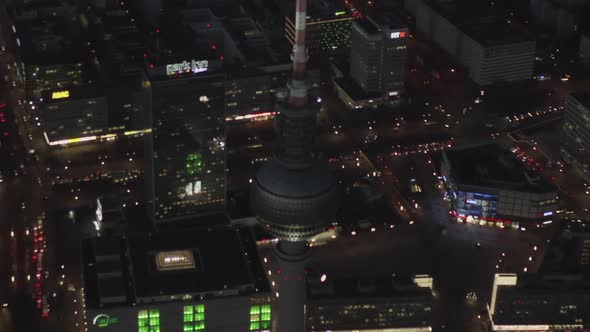 AERIAL: Over Berlin Germany TV Tower Alexanderplatz at Night with City Lights Traffic 