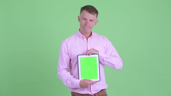 Stressed Businessman Showing Digital Tablet and Getting Bad News