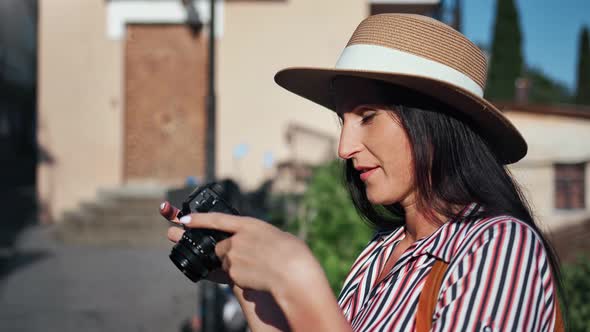 Smiling Female Photographing Exterior Building and Nature