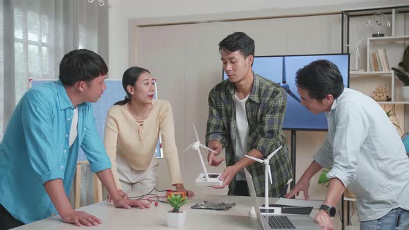 Asian Man And Woman In Engineering Group Arguing During A Meeting About The Wind Turbine