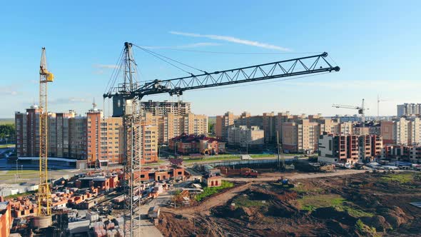 Special Equipment on a Construction Site Builds New Houses for a District alt