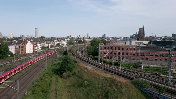 Two commuter S-Bahn trains meet in the north of cologne just before the central station in a midday