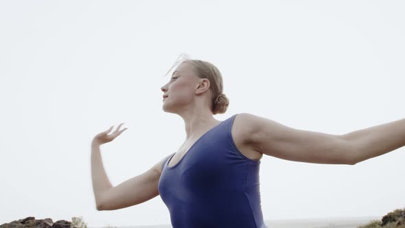 Woman Performs Ballet Smoothly Movements with Her Hands Background Sky Bottom View