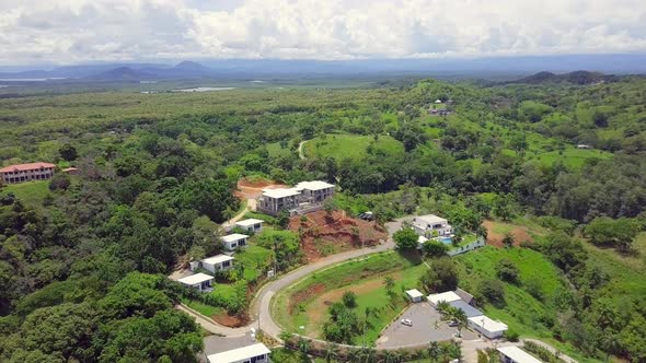 Drone shot of nature view on forest and vacation destination with mountain and cloudy sky background