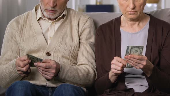 Displeased Mature Couple Showing Dollars on Camera, Pension Reform, Low Budget