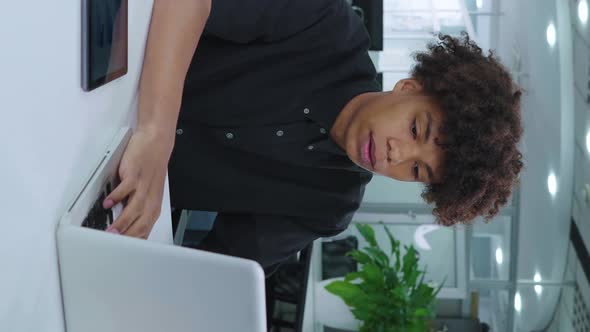 Vertical Screen African American Manager Working in Office