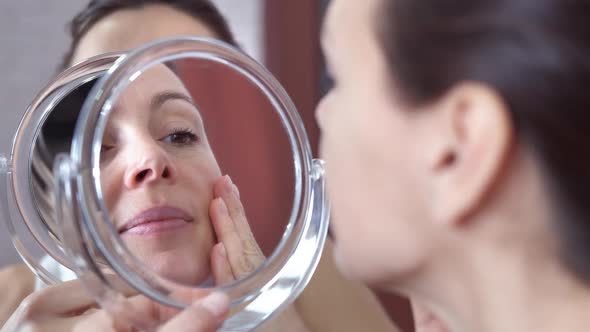 Stressed woman with facial wrinkles. 