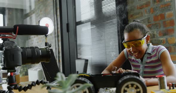Teenage blogger soldering a circuit board 4k