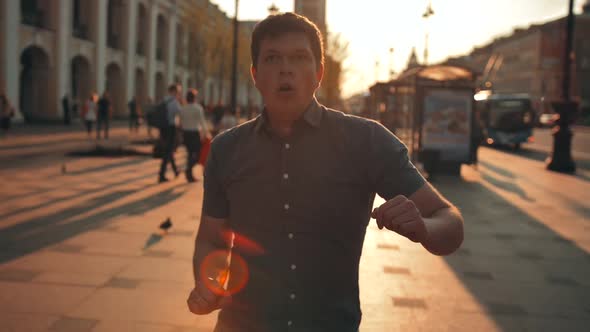 Casual Portrait of Attrctive Young Smiling Male Dancing on City Street.