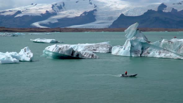 A Boat Floating Among Icebergs