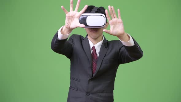 Young Asian Businessman Using Virtual Reality Headset