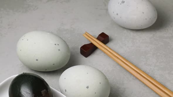 Whole and halved Chinese century eggs close up 