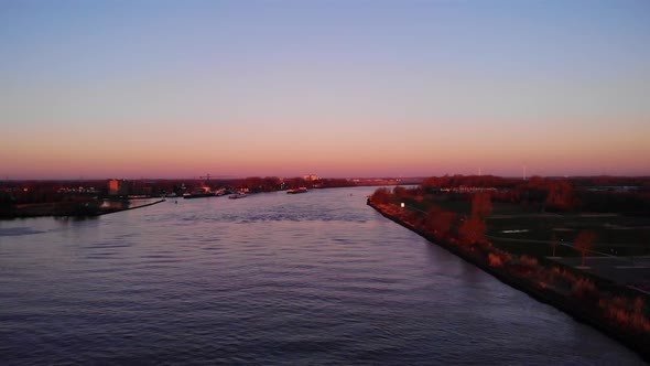 Aerial Rising Dolly Forward Over Oude Maas With Autumnal Sunrise Fall Colours. Establishing Shot