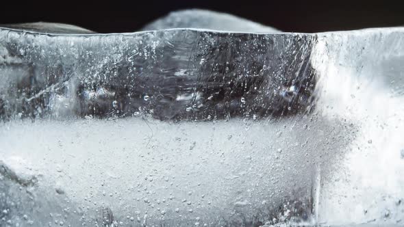 Ice Melts and Rotates on a Black Background