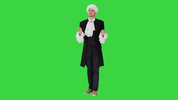 Man Dressed in Courtier Frock Coat and White Wig Thinking and Fidgeting with His Fingers on a Green Screen