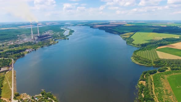 Calm wide river among fields