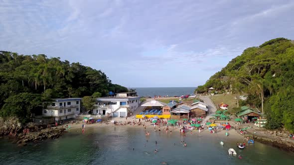 Aerial establishing shot of the Praia da Sepultura and the sea on both sides of a hill