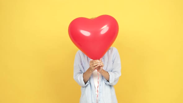 Happy Valentines Day Surprise with Surprised Girl Behind Heart Love Balloon Valentine