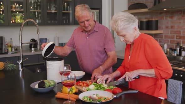 Senior Caucasian couple cooking together in the kitchen