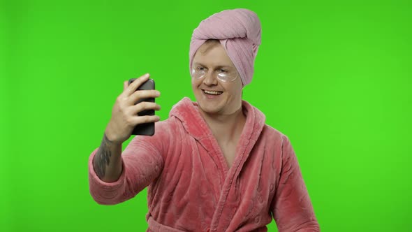 Portrait of Transsexual Man in Bathrobe Using Mobile Phone for Video Call