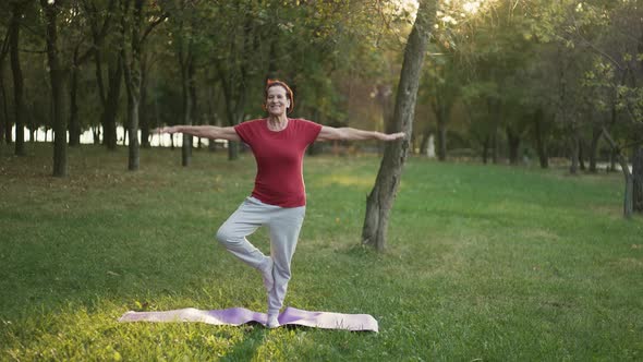 Elderly Woman Do Yoga at the Park