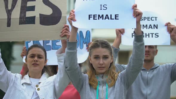 Feminist Protesters Chanting Waving Banners, Protection of Women Rights Equality