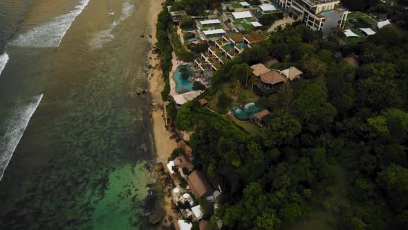 Beautiful Bingin beach with exotic cliffs houses and hotel located in Bali, Indonesia. This drone fo