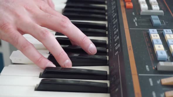 Closeup of hands playing old vintage keyboard from the 70s