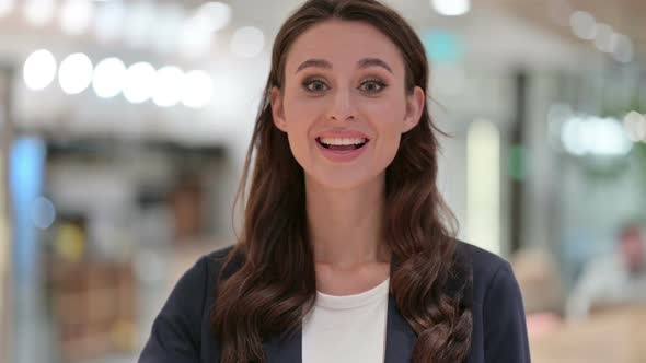 Portrait of Businesswoman Waving at the Camera Welcome