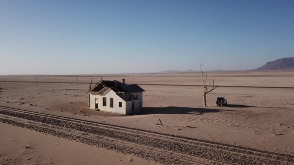 SUV 4X4 Car Parked Near Dried Dead Tree and Garub Railroad Station