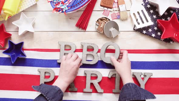 BBQ Time sign with July 4th decorations on a wood boards.