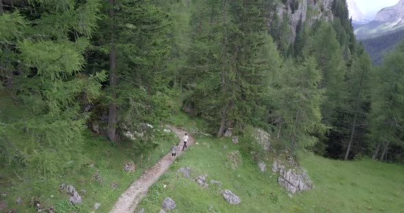 Aerial drone view of hikers hiking in the mountains.